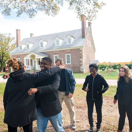 Mason faculty and students in front of Gunston Hall