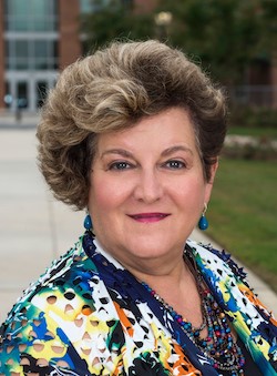 University Professor Faye Taxman smiles at the camera.