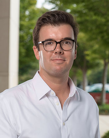 man with glasses and white shirt outside