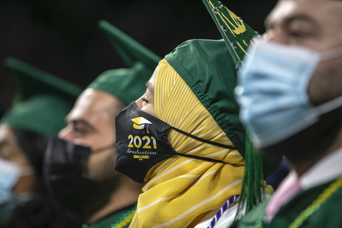 people in caps and gowns at graduation