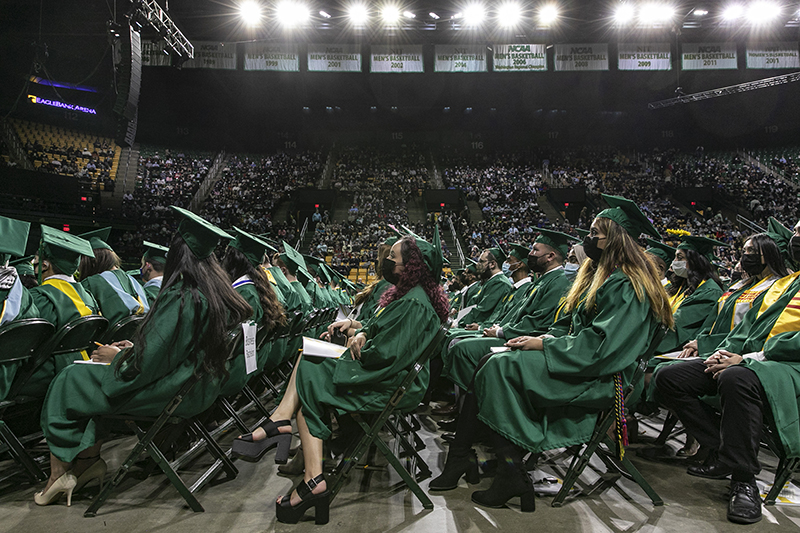 graduates in chairs at graduation