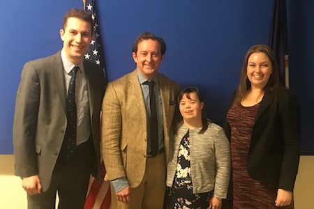 four people against a blue background