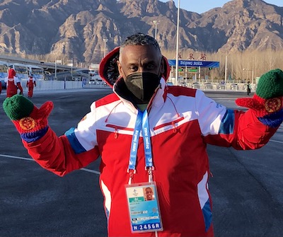 man in a coat posing outside