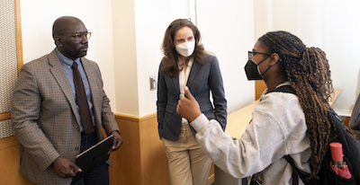 a man and two women discuss something