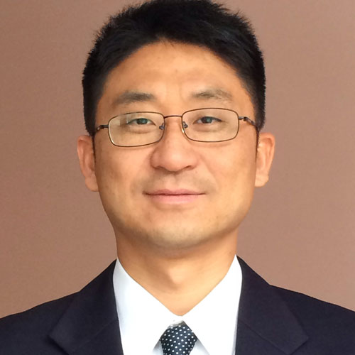 Kun Sun wears a dark suit and tie with glasses in his faculty profile for the Department of Information Sciences and Technology.