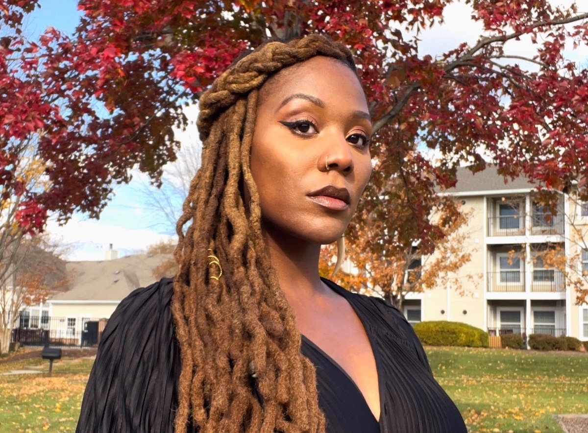 a woman outside standing under trees