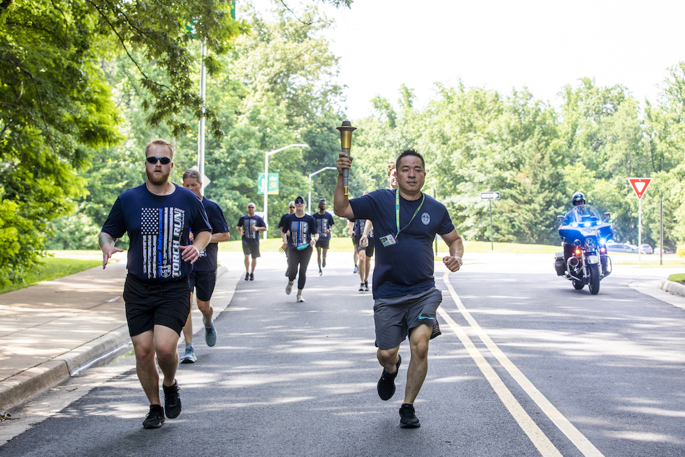 men in blue shirts running outside