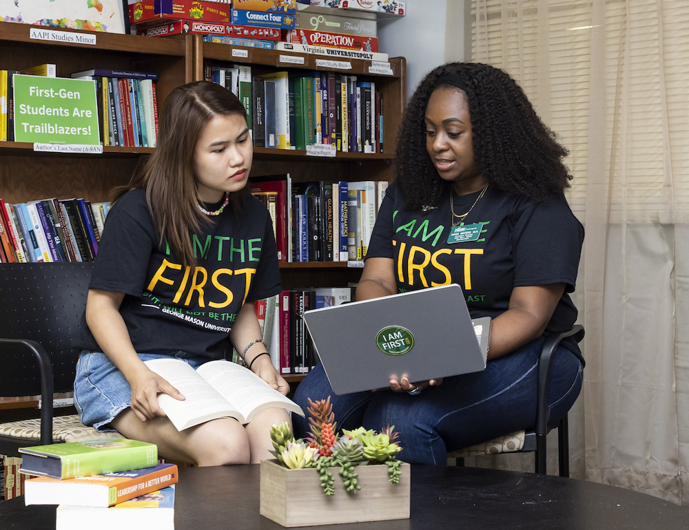 woman and a student look at a laptop