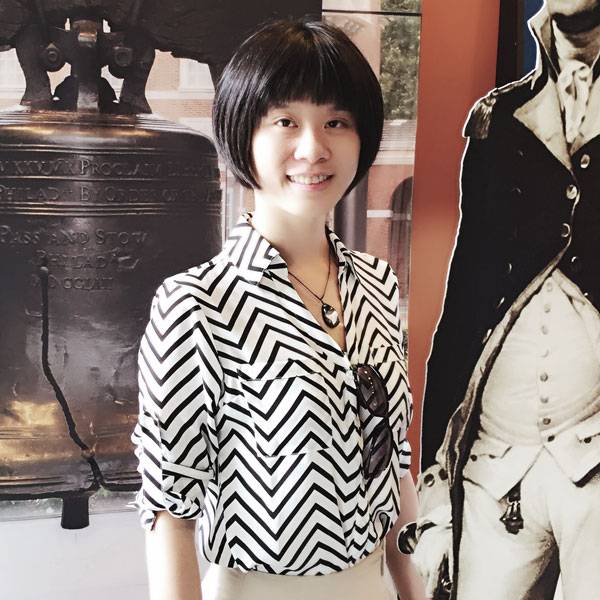 Lisa Luo wears a striped shirt in front of a museum in her profile for the Department of Computer Science.