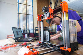 Mason Student works on equipment in The Mix maker space