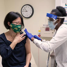Patient receives a vaccination in the upper arm at the clinic. 