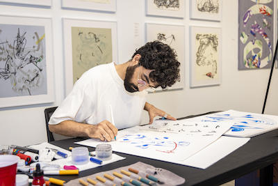 man making art at table