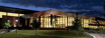 Recreational Athletic Complex (RAC) at Mason, at night with the lights on.