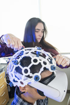 Image of person with a VR helmet set on. 